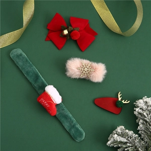 Detailed view of Christmas hair clip set with reindeer horns and festive velvet slap bracelet