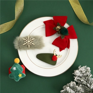 Close-up of Christmas hair accessories with velvet bows and deer antlers on a plate
