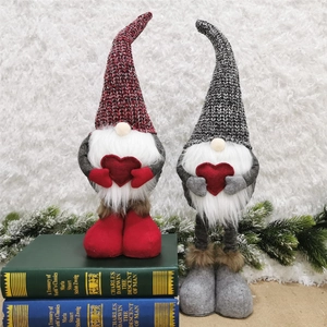 Detail of red and grey gnome ornaments with long white beards and red hearts