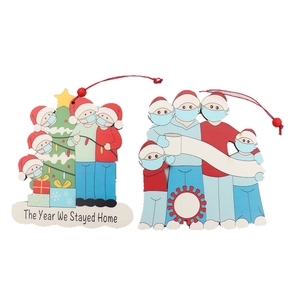 Wooden 2020 Christmas ornaments featuring families with masks and red hanging ropes