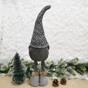 Detail of gray knitted gnome plush with long telescopic legs and faux fur boot accents