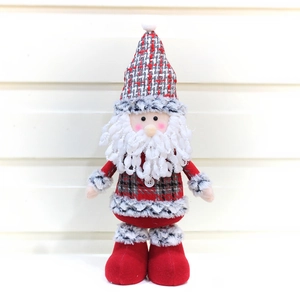 Detail of a plush Santa gnome doll with a red checkered hat and long white beard