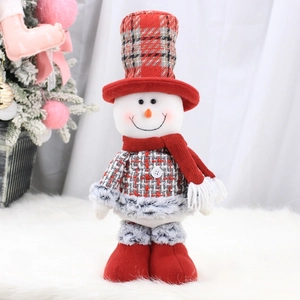 Detail of plush Christmas snowman figurine with red plaid hat and cozy winter knitted scarf