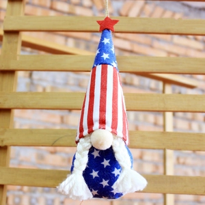 Detail of Independence Day gnome plush with red star hat and patriotic stripes