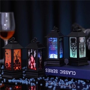 Detail of four Halloween LED lanterns with pumpkin and skull prints for party decor