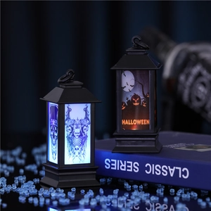 Detail of LED Halloween lanterns with skeleton and pumpkin designs on a dark surface