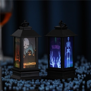 Halloween decorative lanterns featuring orange pumpkin and blue skull lights on mirror surface