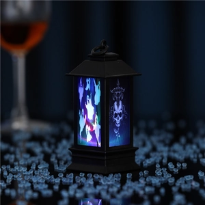 Detail of a black Halloween LED lantern featuring blue ghost light and gothic patterns