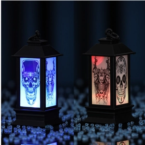 Close-up of Halloween lantern showing skull patterns in blue and red LED light modes