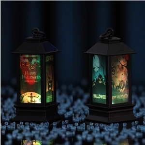 Detail of Halloween LED lanterns with scarecrow and graveyard patterns on blue background