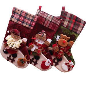 Three large Christmas stockings featuring Santa, Snowman, and Reindeer with plaid cuffs