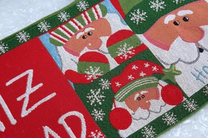 Nahaufnahme der gestrickten Weihnachts-Tischläufer mit Weihnachtsmann und Webstruktur