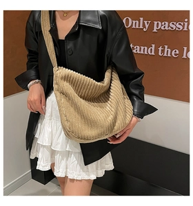 Detail of khaki corduroy tote bag showing soft ribbed texture and large capacity fit