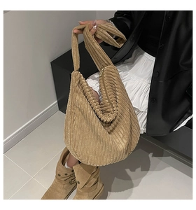 Detail of khaki corduroy tote bag showing textured vertical ribs and soft fabric material