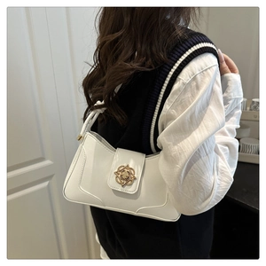 Detail showing the white PU leather underarm bag with a decorative gold geometric buckle