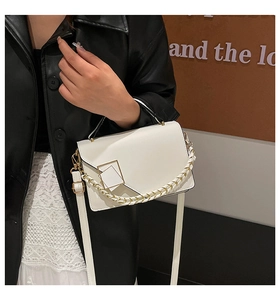 Close-up of white crossbody bag with gold square buckle and three stylish strap options