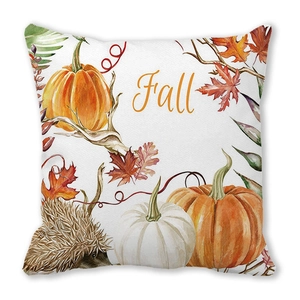 Detail of soft peach skin cushion cover with watercolor pumpkin, hedgehog and leaf patterns
