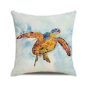 Close-up of artistic watercolor sea turtle print on textured linen cushion cover fabric