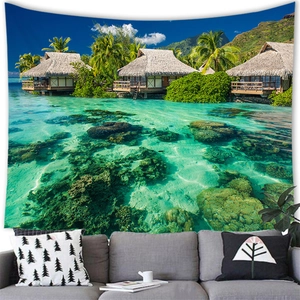 Detail of tropical beach tapestry with water villas and turquoise sea above a sofa