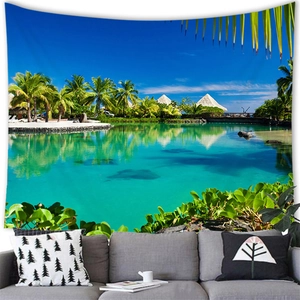 Detailed view of large tropical beach landscape tapestry hanging over a modern grey sofa