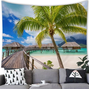 Tropical island tapestry with palm trees and water villas over a modern grey sofa décor