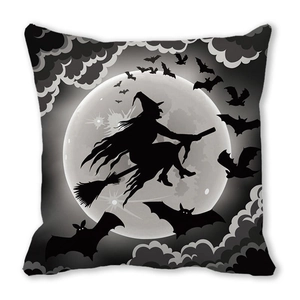 Close-up of Halloween cushion cover with a witch silhouette flying over a full moon