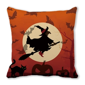 Detail of Halloween pillowcase featuring witch silhouette, bats, and pumpkins on orange