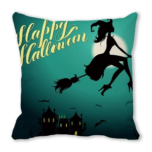 Detail view of Happy Halloween cushion cover featuring witch silhouette and bats on green