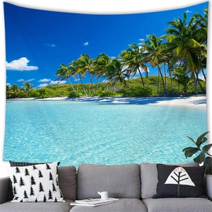 Tropical beach tapestry with palm trees and blue ocean over a modern gray sofa decor