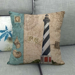 Detail of vintage nautical cushion cover with lighthouse print and maritime elements