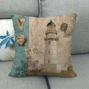 Close-up of linen cushion cover with lighthouse and maritime vintage map patterns