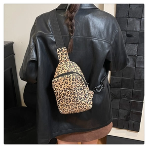 Detail of adjustable strap and leopard print mini chest bag on a model back