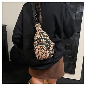 Detailed back view of a leopard print sling bag with adjustable black strap and zipper