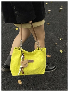 Détail du sac cabas en velours côtelé jaune avec breloque ours et étiquette Creative Cat