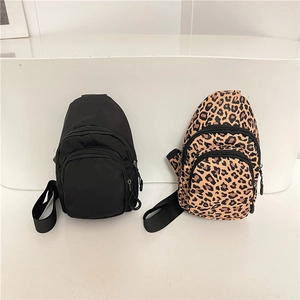 Minimalist crossbody chest bags in solid black and leopard print with adjustable straps