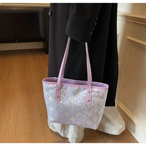 Close-up of light purple tote bag with intricate geometric jacquard and floral textures