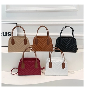 Close-up of quilted crossbody bag in five elegant colors with gold zipper details