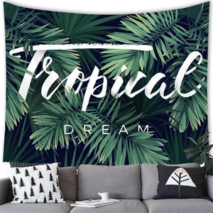 Detailed view of tropical dream tapestry with green palm leaves over a modern sofa