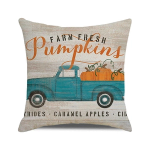 Detail of harvest pumpkin blue truck cushion cover with farm fresh text on rustic wood print
