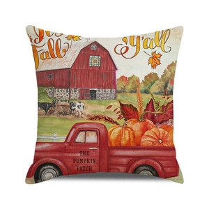 Detail of harvest-themed cushion cover with red truck and pumpkin patch print