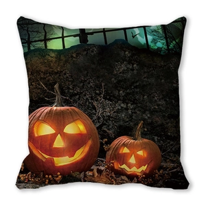 Macro detail of Halloween pillow cover featuring watercolor pumpkins and spooky lanterns