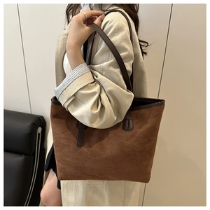 Detail of the soft faux suede texture and dark brown leather trim on this minimalist tote