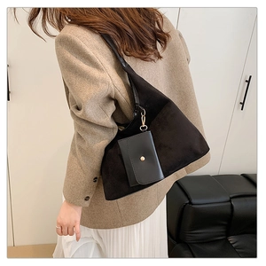 Detail of black suede tote bag with golden metal hook and detachable coin purse