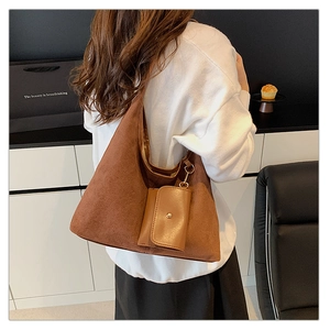 Detail of brown suede hobo bag with matching leather coin purse and inner fabric lining