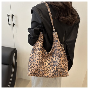 Detailed back view of model wearing a stylish leopard print tote bag with soft canvas texture