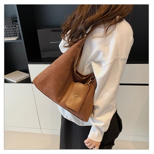 Detail of caramel suede hobo bag with a matching mini pouch for autumn winter style