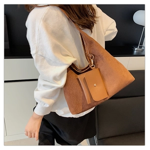 Detailed close-up of brown suede shoulder bag with a matching small coin purse attachment