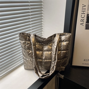 Metallic bronze quilted puffer tote bag with large square pattern and long straps