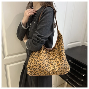 Detail of large leopard print hobo bag with slim shoulder strap for women