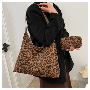 Leopard print tote bag set with matching small zipper pouch shown on model in modern room